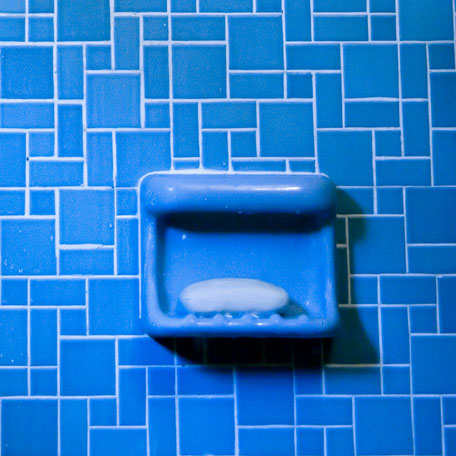 blue soap dish on ceramic tile wall
