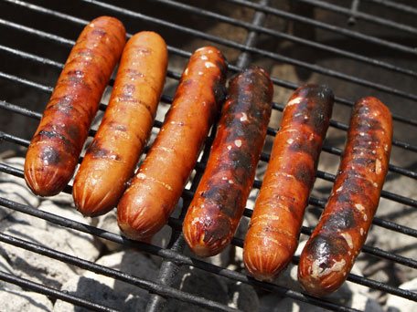 hot dogs on a charcoal grill