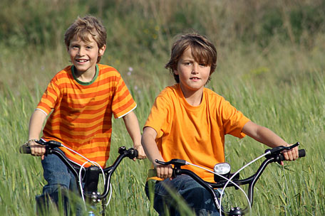 two boys riding bikes